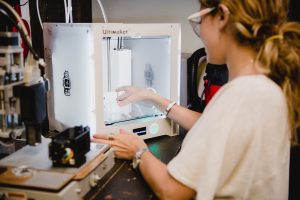 Photo of Female Founders working at the Leslie eLab, with prototyping machine