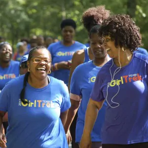 Girl Trek participants, women of color happily going on a walk.