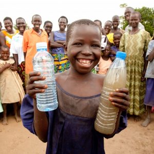 Charity Water promotional image of child smiling with water.