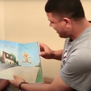 Black man reading to children