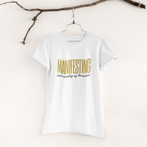 a t shirt that says "manifesting and minding my business"